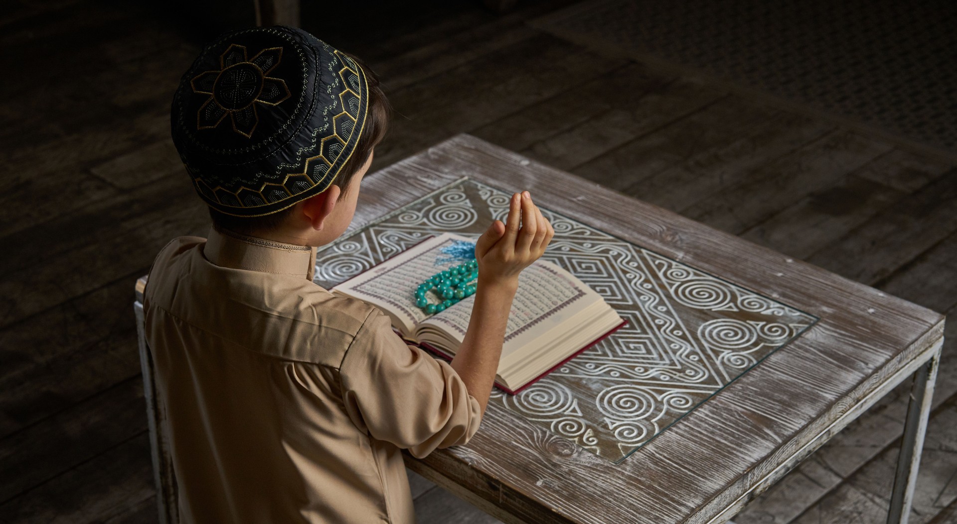 Muslim boy praying to Allah, ramadan celebration concept